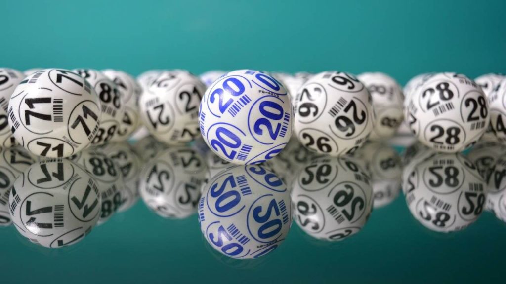 Bolas de bingo numeradas sobre uma mesa de vidro